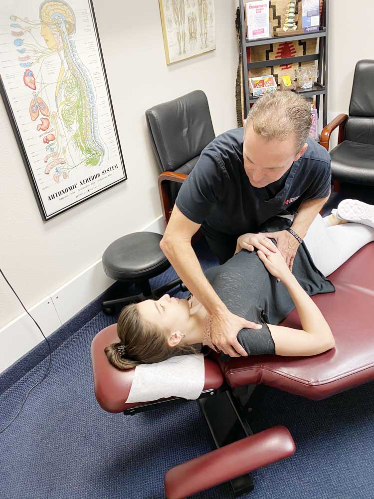 Dr Carl Naehritz, Chiropractor is performing an Lower Back adjustment at Texas Back Care, a Chiropractic Clinic in Hurst Texas